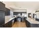Modern kitchen features stainless steel appliances, sleek black cabinetry, island and marble-look countertops at 4878 Califa Dr, Las Vegas, NV 89122