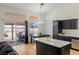 Kitchen features a breakfast bar, stainless steel appliances, black cabinets, and backyard access at 4878 Califa Dr, Las Vegas, NV 89122