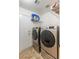 Modern laundry room featuring front-loading washer and dryer, shelving, and a door to the outside at 4878 Califa Dr, Las Vegas, NV 89122