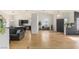 Spacious living room with hardwood floors, modern lighting, and open access to the kitchen at 4878 Califa Dr, Las Vegas, NV 89122