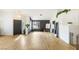 Open floor plan living room with hardwood floors, modern lighting, and large windows at 4878 Califa Dr, Las Vegas, NV 89122