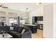 Comfortable living area with hardwood floors, contemporary lighting, and kitchen access at 4878 Califa Dr, Las Vegas, NV 89122