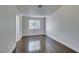 Bedroom featuring hardwood floors, base trim, large window, and neutral paint at 5330 E Charleston Blvd # 2, Las Vegas, NV 89142
