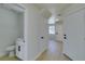 Bright hallway featuring modern flooring, fresh paint, and a convenient powder room at 5330 E Charleston Blvd # 2, Las Vegas, NV 89142