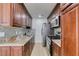 Stylish kitchen with rich wood cabinetry, granite counters, stainless steel appliances, and tile backsplash at 5330 E Charleston Blvd # 2, Las Vegas, NV 89142