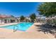 Community pool with lounge chairs and surrounding landscaped area at 5330 E Charleston Blvd # 2, Las Vegas, NV 89142