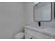 This minimalist powder room features a sleek black framed mirror and quartz countertops at 5330 E Charleston Blvd # 2, Las Vegas, NV 89142
