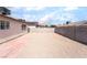 Large backyard featuring a concrete block wall, gravel landscaping, and brick patio at 5751 Mabel Rd, Las Vegas, NV 89110