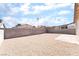 Expansive backyard with gravel, block wall, and brick patio, offering a low-maintenance outdoor space at 5751 Mabel Rd, Las Vegas, NV 89110