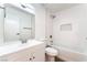Bathroom featuring a vanity, commode, tub, and a shower with a tiled backsplash and a shower niche at 5751 Mabel Rd, Las Vegas, NV 89110