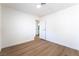 Bright bedroom featuring light wood floors and white walls, with an open doorway to an adjacent room at 5751 Mabel Rd, Las Vegas, NV 89110