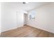 Bright bedroom with light wood floors, closet with sliding doors, and a window for natural light at 5751 Mabel Rd, Las Vegas, NV 89110