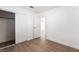 Bright bedroom featuring light wood floors and an open closet, with an open doorway to an adjacent room at 5751 Mabel Rd, Las Vegas, NV 89110