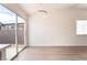 Bright dining area with light wood floors, a modern light fixture, and sliding glass doors offering a view of the backyard at 5751 Mabel Rd, Las Vegas, NV 89110