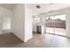 Dining area with white walls, light wood floors, a modern light fixture, and sliding glass doors to the backyard at 5751 Mabel Rd, Las Vegas, NV 89110