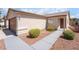 Single-story home with desert landscaping, a walkway to the front door, and an attached two-car garage at 5751 Mabel Rd, Las Vegas, NV 89110