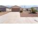 Charming single-story home featuring a well-maintained front yard with desert landscaping and a two-car garage at 5751 Mabel Rd, Las Vegas, NV 89110