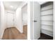 Bright hallway with wood floors, leading to a room and featuring a storage closet with shelves at 5751 Mabel Rd, Las Vegas, NV 89110