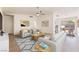 Bright, modern living room with neutral tones, ceiling fan, and comfortable seating arrangement at 5751 Mabel Rd, Las Vegas, NV 89110