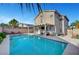This home offers a pristine backyard swimming pool with an outdoor kitchen, TV, and gazebo at 5823 Rose Sage St, North Las Vegas, NV 89031