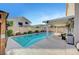 This backyard provides a refreshing pool and covered seating area to enjoy this home's attractive exterior at 5823 Rose Sage St, North Las Vegas, NV 89031