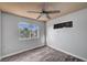 Bedroom with hardwood floors, a ceiling fan, and a view of palm trees outside the window at 5823 Rose Sage St, North Las Vegas, NV 89031