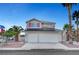 Two-story home featuring a three-car garage, solar panels, and desert landscaping, perfect for Las Vegas living at 5823 Rose Sage St, North Las Vegas, NV 89031