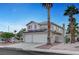 Charming two-story home with three-car garage, solar panels, desert landscaping, and palm trees at 5823 Rose Sage St, North Las Vegas, NV 89031