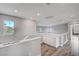 Hallway area featuring wood-look floors, white walls, and a window with natural light at 5823 Rose Sage St, North Las Vegas, NV 89031