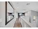 Upstairs hallway featuring hardwood floors, modern lighting, and a large mirror at 5823 Rose Sage St, North Las Vegas, NV 89031