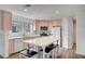 Bright kitchen features stainless steel appliances, pink cabinets, and a center island with seating at 5823 Rose Sage St, North Las Vegas, NV 89031