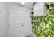 Laundry room features cabinets and tropical themed wallpaper at 5823 Rose Sage St, North Las Vegas, NV 89031