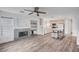 Open living room with a fireplace, built-in shelves, and view of the kitchen and center island at 5823 Rose Sage St, North Las Vegas, NV 89031