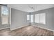Bright living room featuring wood-look floors and ample natural light from numerous windows at 5823 Rose Sage St, North Las Vegas, NV 89031