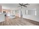 Spacious living room showcasing wood-look floors and an open layout with views of the kitchen at 5823 Rose Sage St, North Las Vegas, NV 89031