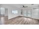 Bright living room boasts new wood floors, a ceiling fan, and access to the backyard pool at 5823 Rose Sage St, North Las Vegas, NV 89031