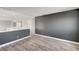 Loft area featuring wood-look floors, a grey accent wall, and a white railing at 5823 Rose Sage St, North Las Vegas, NV 89031
