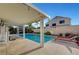 A pristine swimming pool is surrounded by a patio, lounge chairs, and lush landscaping in this backyard oasis at 5823 Rose Sage St, North Las Vegas, NV 89031
