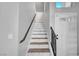 Bright staircase featuring light walls, decorative stairs, and a dark stained wood handrail at 5823 Rose Sage St, North Las Vegas, NV 89031