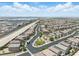 A high-angle view of a residential area showcasing a community park and railway tracks in the distance at 6322 Angora Peak Ln, Las Vegas, NV 89115