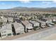 Extensive aerial view of a residential community featuring modern homes, solar panels, and mountain views at 6322 Angora Peak Ln, Las Vegas, NV 89115