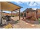 Backyard featuring a fire pit, shaded outdoor seating, and low maintenance desert landscaping at 6322 Angora Peak Ln, Las Vegas, NV 89115