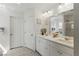 This bathroom offers double sinks, a large mirror, and all-white cabinets and walls at 6322 Angora Peak Ln, Las Vegas, NV 89115