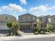 Charming two-story home featuring a brick-paved driveway and beautifully landscaped front yard at 6322 Angora Peak Ln, Las Vegas, NV 89115