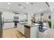 Bright, spacious kitchen featuring white cabinetry, granite countertops, and stainless steel appliances at 6322 Angora Peak Ln, Las Vegas, NV 89115