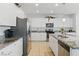 Bright, spacious kitchen featuring white cabinetry, granite countertops, and stainless steel appliances at 6322 Angora Peak Ln, Las Vegas, NV 89115