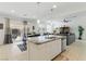 Bright, open kitchen flows into living area, showcasing granite countertops and stainless steel appliances at 6322 Angora Peak Ln, Las Vegas, NV 89115