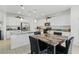 Bright, spacious kitchen featuring white cabinetry, granite countertops, and stainless steel appliances at 6322 Angora Peak Ln, Las Vegas, NV 89115