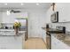 Bright, spacious kitchen featuring white cabinetry, granite countertops, and stainless steel appliances at 6322 Angora Peak Ln, Las Vegas, NV 89115