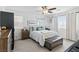 Comfortable main bedroom showcasing ceiling fan, neutral palette, and ample natural light at 6322 Angora Peak Ln, Las Vegas, NV 89115